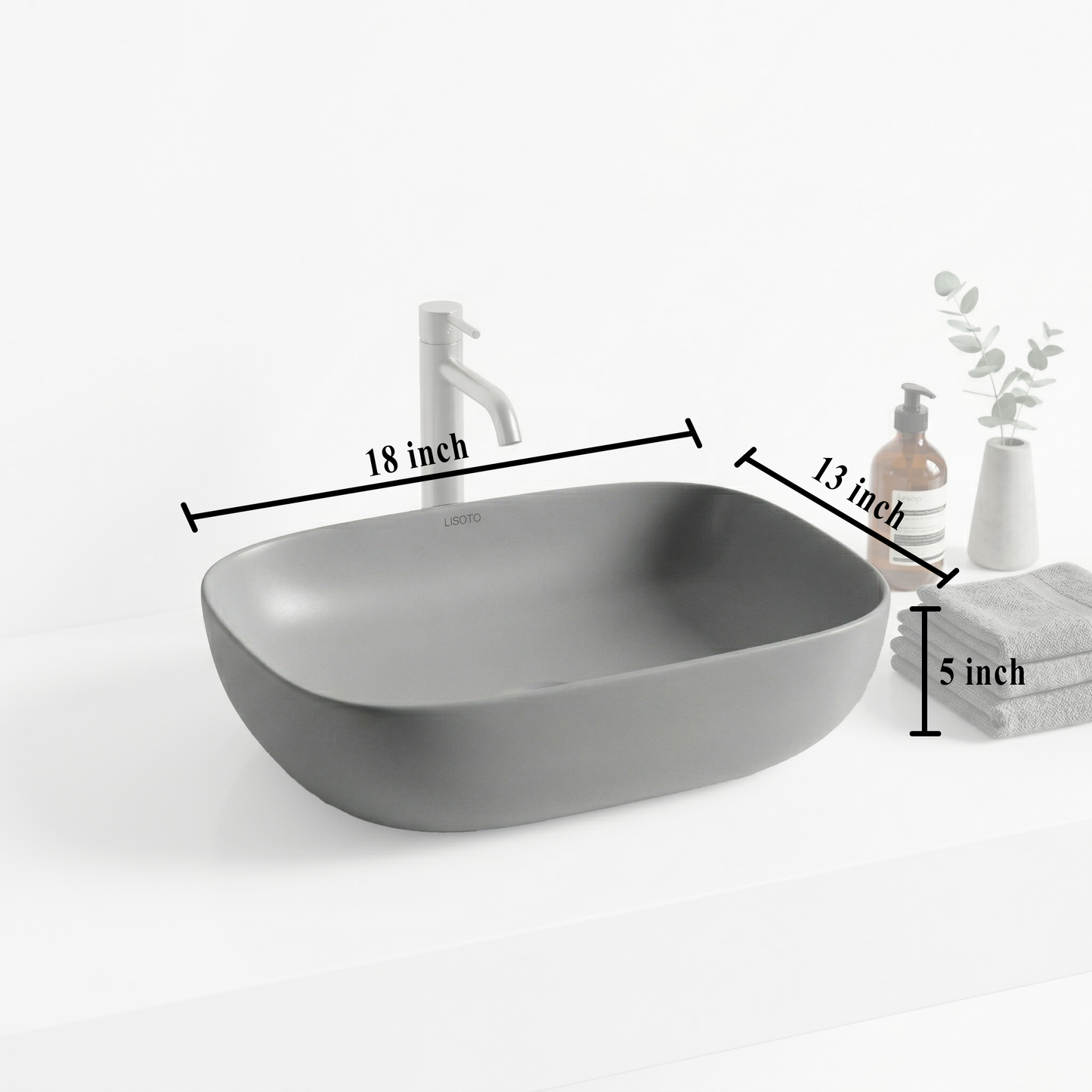Gray matte table top basin and bathroom accessories on a countertop