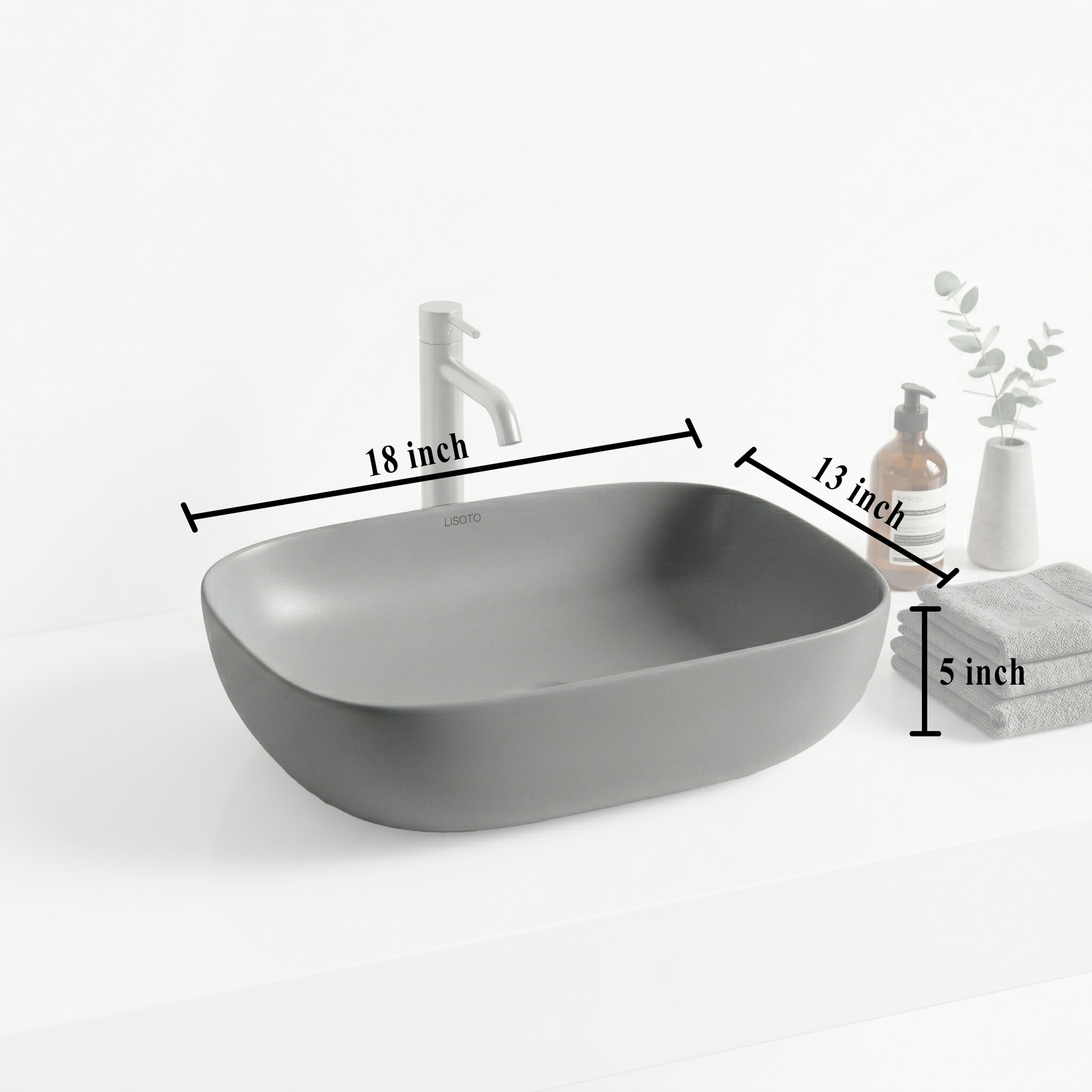 Gray matte table top basin and bathroom accessories on a countertop