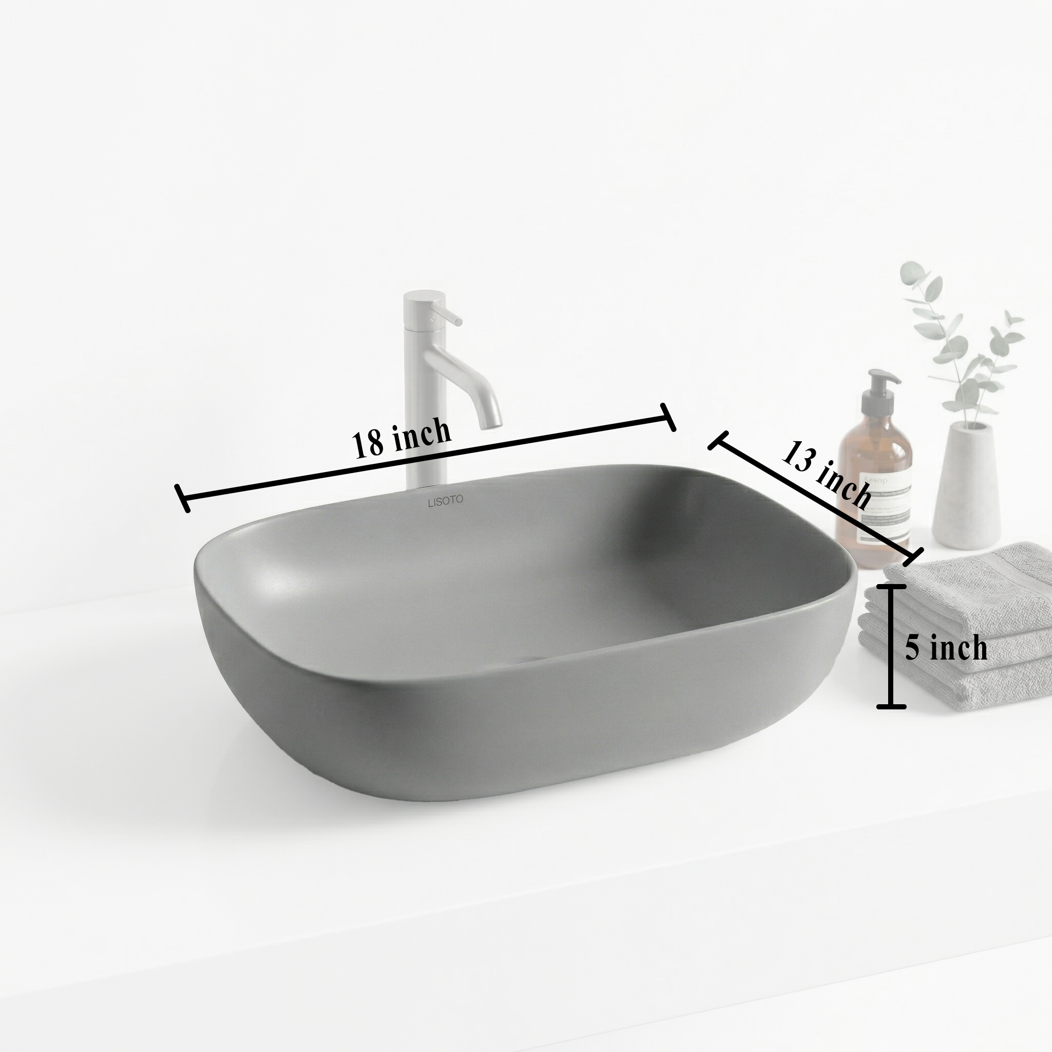Gray matte table top basin and bathroom accessories on a countertop